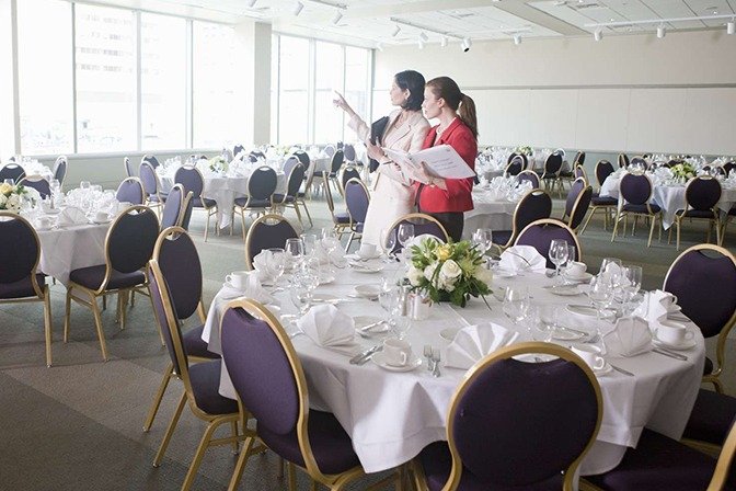 Professional event organizer managing corporate event setup